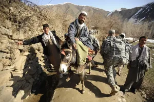 Candid Group Portrait Prints: U.S. Army soldiers of the Panjshir Provincial Reconstruction Team walk past villagers in Panjshir Valley Afghanistan