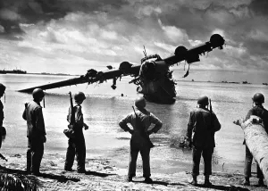 Lcgr1310 Prints: U.S. Army troops look at the ruins of a Japanese seaplane in the lagoon near Makin Island