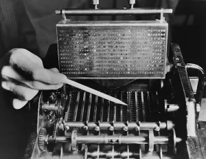 Records Prints: U.S. Bureau of the Census computer operator pointing out the interior mechanism of the punched card sorter
