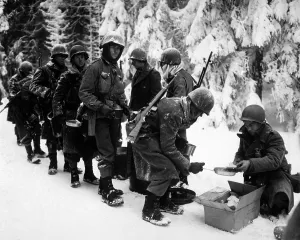Cold Prints: U.S. Infantrymen at field mess on their way to La Roche