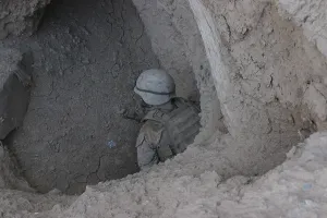 Images Dated 16th March 2011: U.S. Marine in a suspected enemy passageway near Now Zad Afghanistan Oct