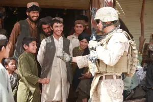 Candid Occupational Portrait Prints: A U.S. Marine talks with Afghans in the Salaam Bazaar during to gather intelligence about seeking Taliban hideouts