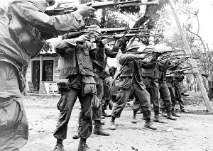 Images Dated 17th May 2007: U.S. Marines advance down a street in Hue