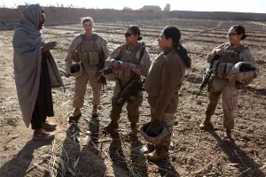 Candid Group Portrait Prints: U.S. Marines in Afghanistan assigned to a female engagement team speak with a local Afghan man in his compound during a