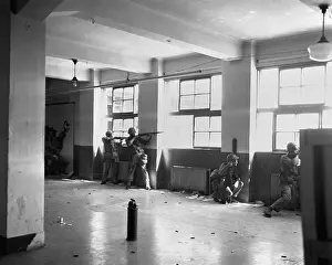 Korea Prints: U.S. Marines in concrete building firing from alternate positions to present bobbing targets