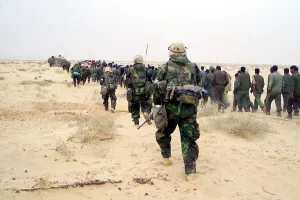 Prisoners Of War Prints: U.S. Marines escort captured enemy prisoners of war to a holding area in the desert of Iraq on March 21 2003 during