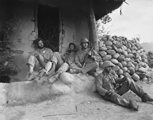 Combat Action Prints: U.S. Marines relax after killing an enemy sniper housed in the Korean hut
