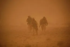 Images Dated 16th March 2011: U.S. Marines in a sand storm returning to their vehicles after patrolling a nearby mountain ridge in Bakwa Afghanistan