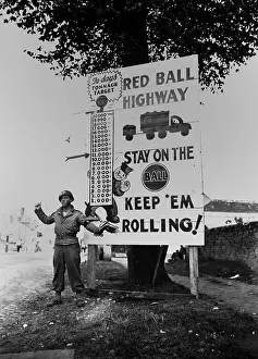 Trucks Prints: U.S. MP waves on a Red Ball Express motor convoy near Alencon, France, Sept. 5, 1944