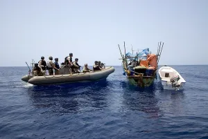 Piracy Prints: U.S. Navy and Coast Guard counter piracy personnel approach a suspect vessel while under way in the Gulf of Aden