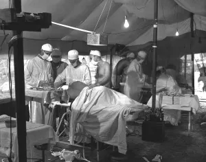 Surgeons Prints: U.S. Navy doctors and corpsmen operate on two wounded Marines on Cape Gloucester