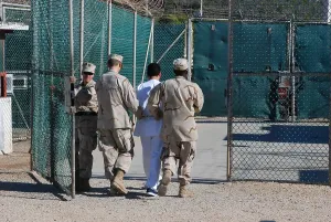 Candid Occupational Portraits Prints: U.S. Navy guards escort a detainee through Camp Delta the military prison for enemy combatants many believed to be