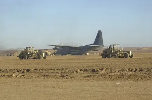 Images Dated 16th March 2011: U.S. Navy Seabees run heavy graders down the runway to patch holes