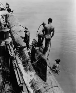 Hawaii Prints: U.S. Navy tug raises one of eight Japanese midget subs from Pearl Harbor, July 17, 1943