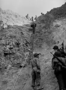 Tools Prints: U.S. Rangers climb a cliff using a rope ladders at the Pointe du Hoc, Normandy