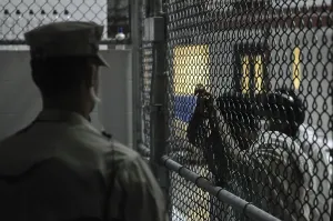 Candid Occupational Portraits Prints: U.S. Sailor stands watch over a cell block at U.S