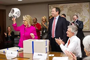 Clapping Prints: U.S. Sec. of State Hillary Clinton is presented with a football helmet at the State Department
