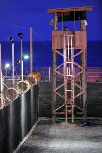 Cuba Prints: U.S. Soldier stands watch in a guard tower at Camp Delta in Guantanamo Bay Naval Base Cuba