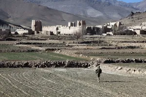 Candid Occupational Portrait Prints: U.S. Soldier walks through a field to Dahanah village Wardak province Afghanistan