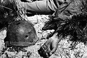 Death Portraits Prints: U.S. soldier's bullet-pierced helmet lying next to his body in a South Korean battlefield