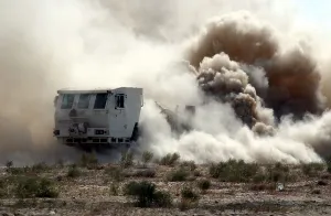 Images Dated 16th March 2011: U.S. soldiers employ a mine clearing vehicle near the Bagram Air Base Afghanistan