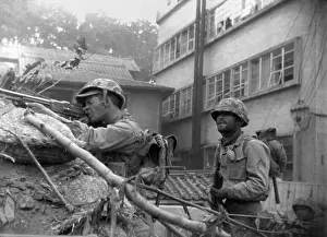 Barricades Prints: U.S. soldiers fire from behind a barricade at Communist-led North Korean forces in the streets of Seoul