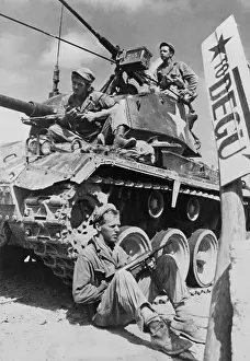 Machine Guns Prints: U.S. soldiers guard a roadblock on the Naktong River front in the Taegu area with an M-24 tank