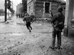 Snipers Prints: U.S. soldiers moving through the streets of Cherbourg