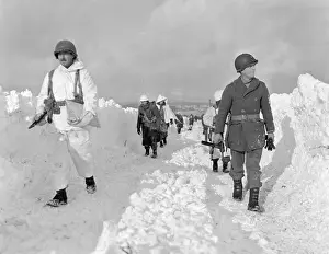 Belgium Prints: U.S. soldiers patrol on a path plowed through snow in the Ardennes during the Battle of the Bulge