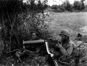 Hedgerows Prints: Two U.S. soldiers positioned in a Normandy hedgerow with a water-cooled Browning machine gun