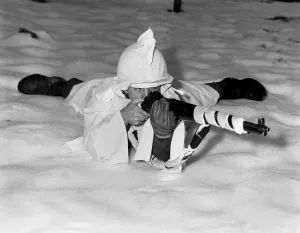 Cold Prints: U.S. technical sergeant in the new snow cape used by infantrymen in snow-covered areas in Belgium