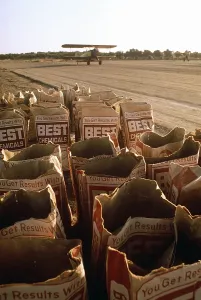 Chemicals Prints: Used bags of Best Chemical bags next to a runway where a bi-plane is about to take off to spread the chemicals over