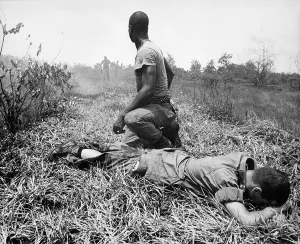 Republic Of Vietnam Prints: Vietnam War. An African American Infantry medic treats a lieutenant's leg