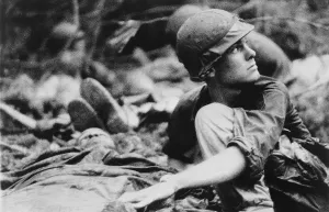 Republic Of Vietnam Prints: Vietnam War. Army medic searches the sky for a Medevac helicopter to evacuate wound soldiers