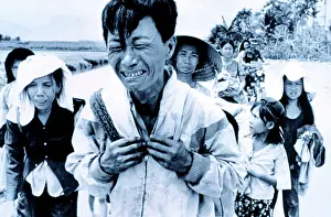 Crying Prints: Vietnam War: A head of family weeps as his family is forced to migrate March 29