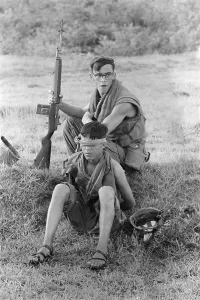 Republic Of Vietnam Prints: Vietnam War. A US Marine corporal guards an bound