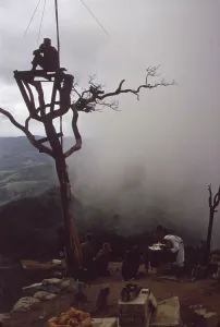 Republic Of Vietnam Prints: Vietnam War. US Marine stands watch in an observation tower as a Marine chaplain holds mass on Hill 950