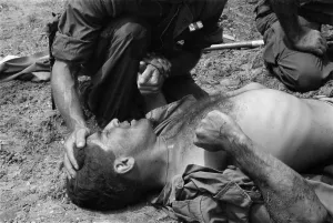 Republic Of Vietnam Prints: Vietnam War. US Marine wounded by a Viet Cong booby trap is comforted by a fellow Marine