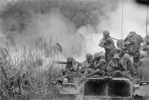 Republic Of Vietnam Prints: Vietnam War. Marines riding atop an M-48 tank cover their ears as the 90mm gun fires southwest of Phu Bai