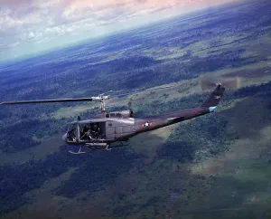 Mission Prints: Vietnam War, side view of a Vietnamese Air Force UH-1H helicopter in flight over Southeast Asia
