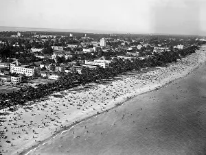 Beach Prints: A view of the beach at Miami, Florida showing thousands of bathers enjoying the sun