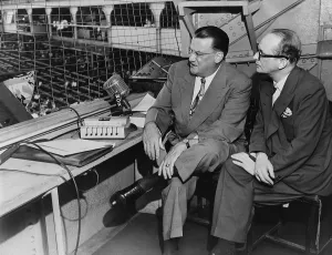 Images Dated 14th December 2010: Walter O'Malley 1903-1979 owner of the Brooklyn Dodgers in the press box at Ebbets Field discussing subscription TV