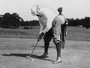 Recreation Prints: Warren G. Harding bending over to hit a golf ball