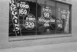 Chevrolet Prints: In Washington, D.C. a used automobile dealer advertises prices on its showroom window