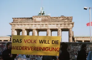Communism Prints: West German citizens display a banner THE PEOPLE WILL BE AGAIN REUNITED as they wait for demolition of the Berlin Wall