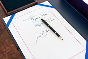 Biden Prints: White House staff arranges the signing page and box holding the full text of the American Rescue Plan Act of 2021