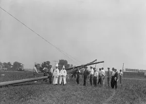 Nativists Prints: Two white robed Ku Klux Klansmen supervise the erection of 80 ft