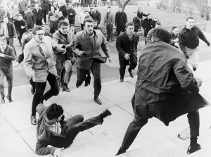 April Prints: White students running toward an African American during period of racial violence at Collinwood High School