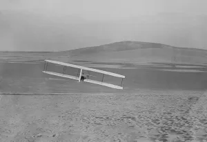 Flyers Prints: Wilbur Wright 1867-1912 making a right turn in a glider at Kitty Hawk North Carolina