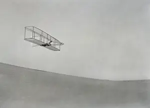 Technology Prints: Wilbur Wright gliding above the slope of Big Kill Devil Hill at Kitty Hawk